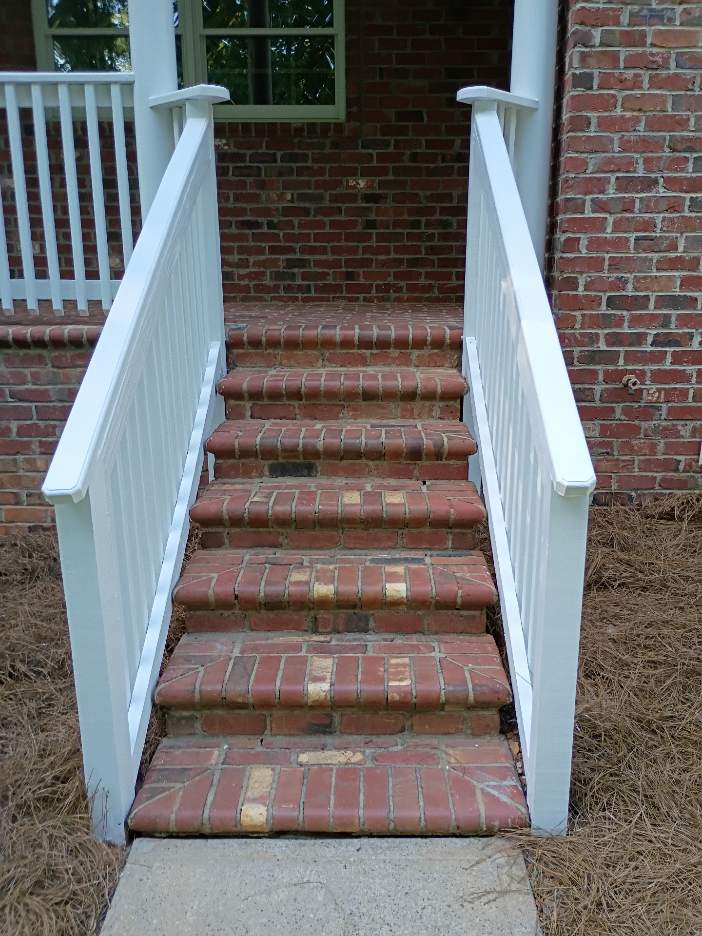 Brick stairs with new painted railings